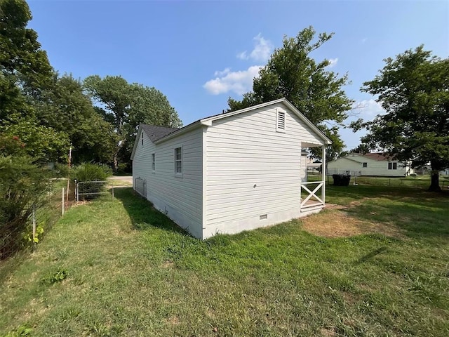 view of side of home featuring a yard