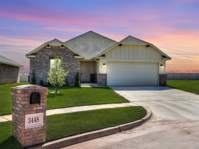 view of front of home featuring a garage and a lawn