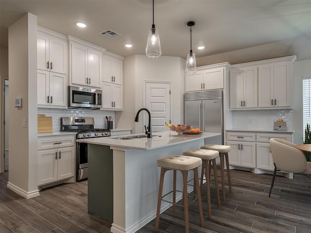 kitchen featuring appliances with stainless steel finishes, sink, and white cabinets