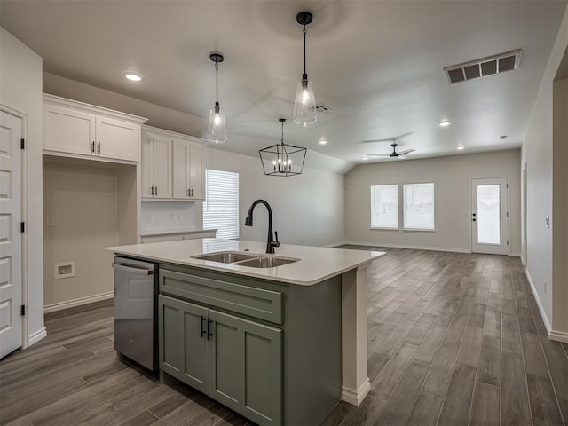 kitchen with decorative light fixtures, dishwasher, white cabinetry, sink, and an island with sink