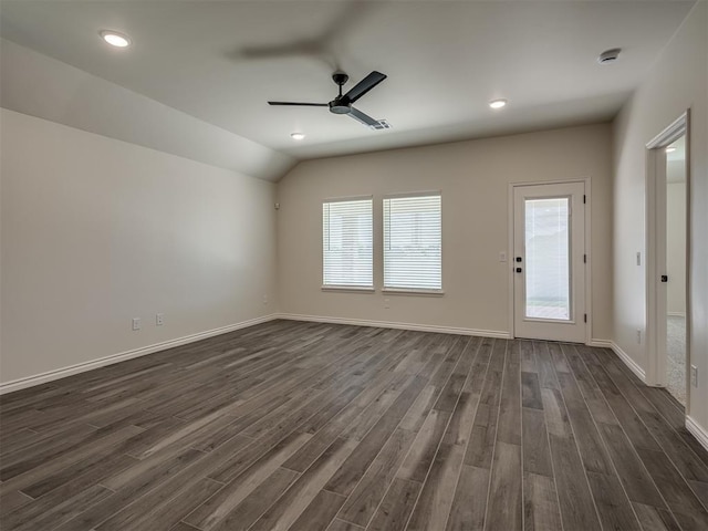 spare room featuring dark wood-type flooring, ceiling fan, and lofted ceiling