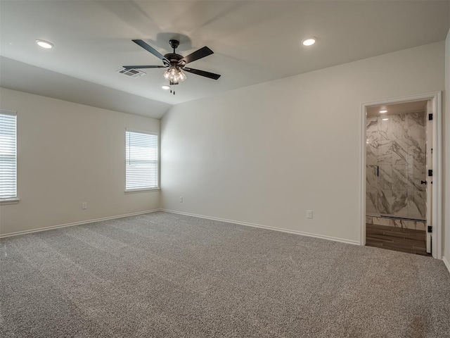 carpeted spare room with vaulted ceiling and ceiling fan