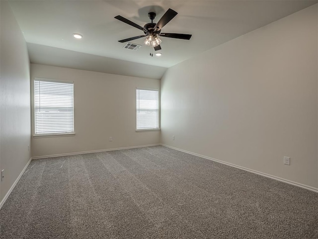 carpeted empty room featuring lofted ceiling and ceiling fan