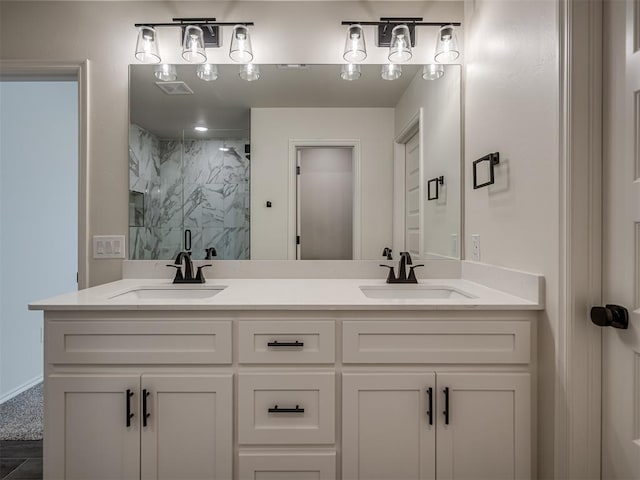 bathroom featuring an enclosed shower and vanity