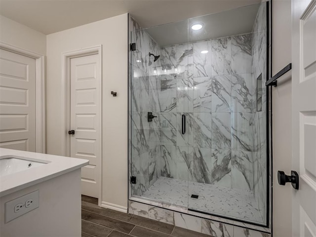 bathroom with walk in shower and vanity