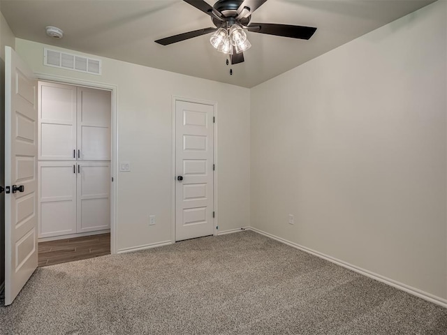 unfurnished bedroom featuring carpet floors and ceiling fan