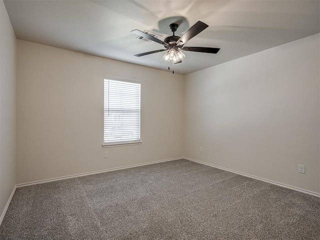 spare room with ceiling fan and carpet