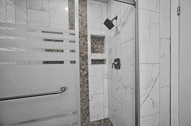 bathroom with tiled shower