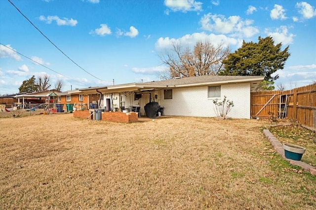 back of house with a lawn