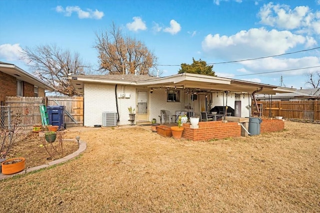 rear view of house featuring a patio area, a lawn, and central AC