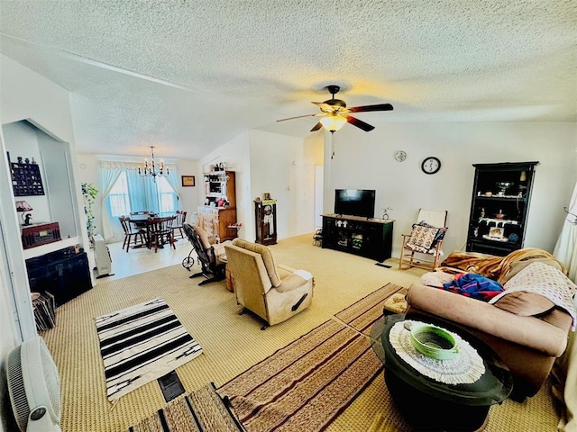 carpeted living room with vaulted ceiling, ceiling fan with notable chandelier, and a textured ceiling