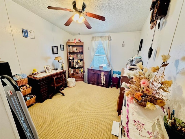 carpeted office space featuring a textured ceiling and ceiling fan