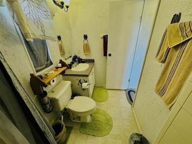 bathroom featuring toilet and vanity