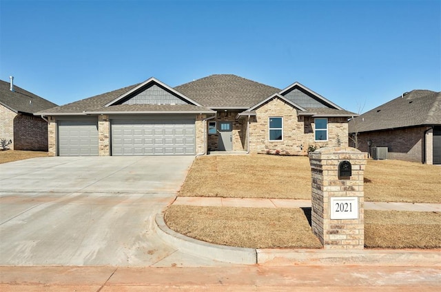 craftsman-style home featuring a garage and central AC unit