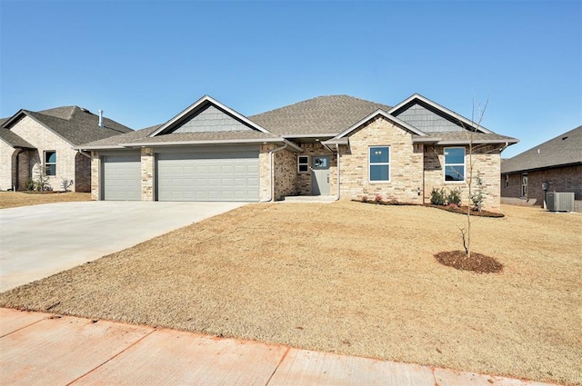 craftsman inspired home with a garage, a front lawn, and cooling unit