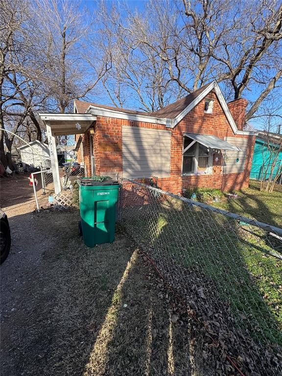 view of side of property with a lawn