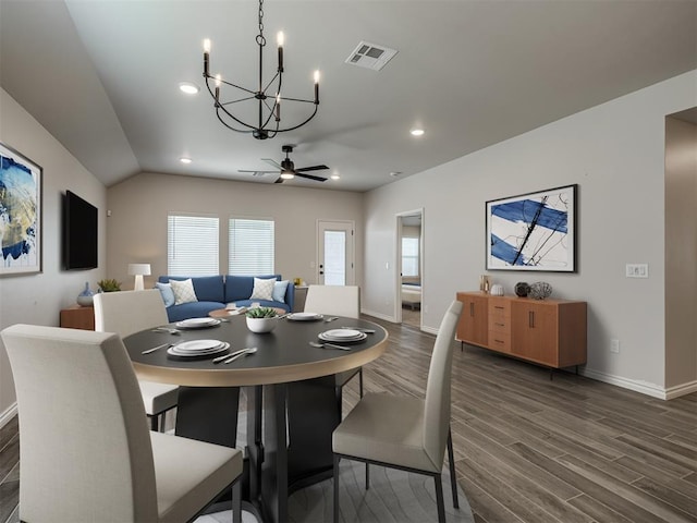 dining space with ceiling fan with notable chandelier, baseboards, dark wood-type flooring, visible vents, and recessed lighting