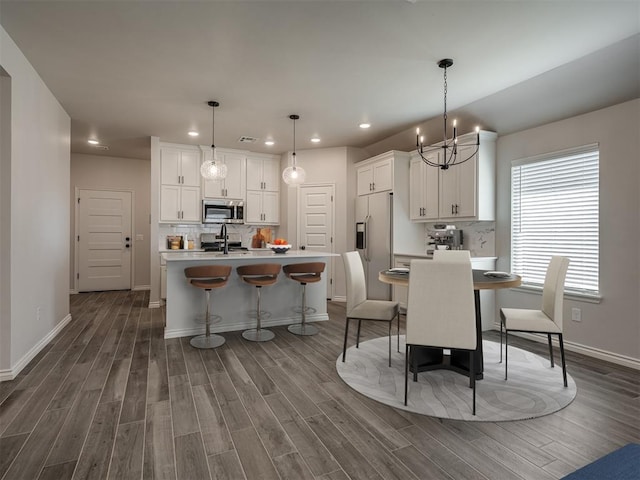 dining area featuring recessed lighting, a chandelier, and dark wood finished floors