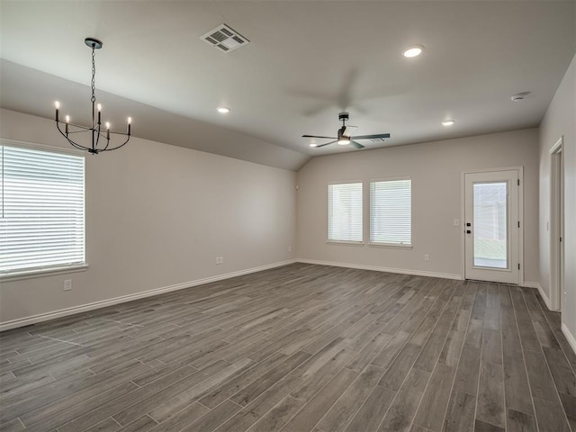 unfurnished living room with dark wood finished floors, visible vents, baseboards, and ceiling fan with notable chandelier