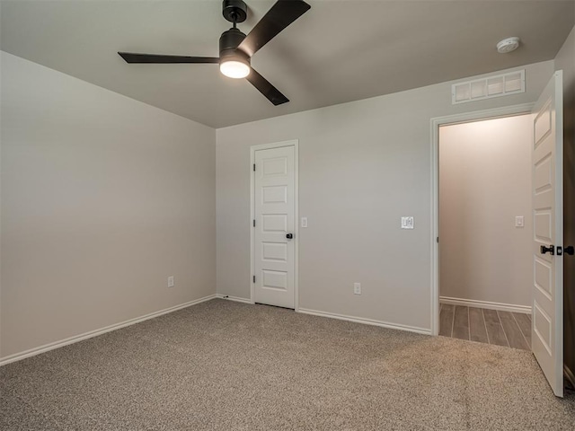 unfurnished bedroom featuring ceiling fan, baseboards, carpet flooring, and visible vents