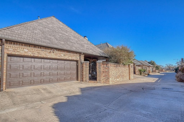 344 Millbrook Dr, Norman, OK 73072 - view of side of property featuring a garage