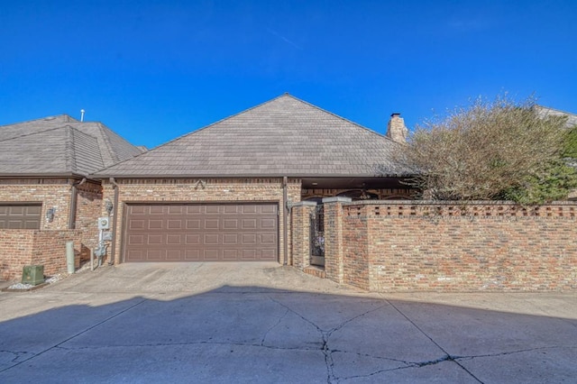 344 Millbrook Dr, Norman, OK 73072 - view of side of home featuring a garage