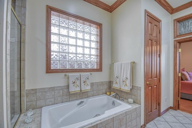 344 Millbrook Dr, Norman, OK 73072 - bathroom featuring tile patterned flooring, crown molding, and a relaxing tiled tub