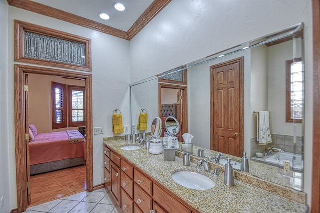 344 Millbrook Dr, Norman, OK 73072 - bathroom featuring ornamental molding, tile patterned floors, a bathtub, and vanity
