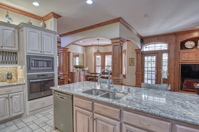 344 Millbrook Dr, Norman, OK 73072 - kitchen with light stone counters, appliances with stainless steel finishes, sink, and decorative columns