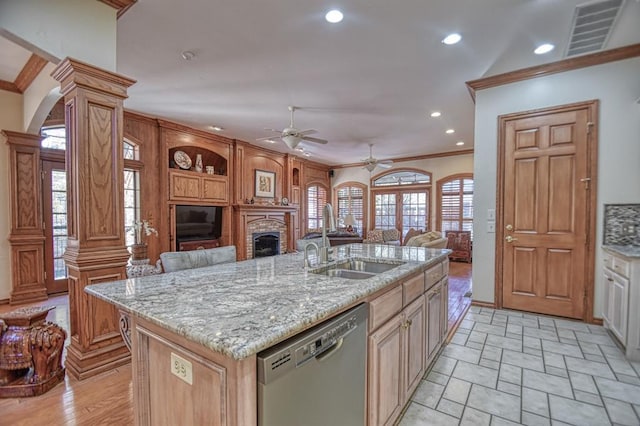 344 Millbrook Dr, Norman, OK 73072 - kitchen with sink, crown molding, a kitchen island with sink, stainless steel dishwasher, and ornate columns