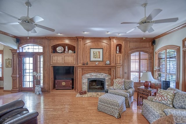 344 Millbrook Dr, Norman, OK 73072 - living room featuring ornamental molding, ceiling fan, a fireplace, and light hardwood / wood-style flooring