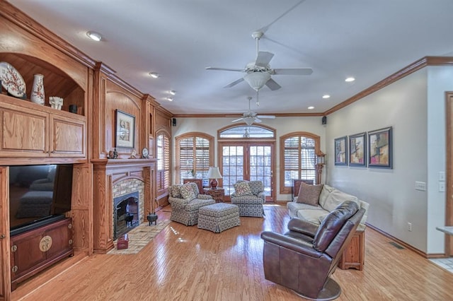344 Millbrook Dr, Norman, OK 73072 - living room featuring ornamental molding, ceiling fan, a fireplace, and light hardwood / wood-style flooring