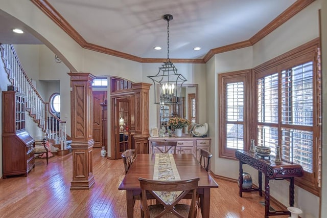 344 Millbrook Dr, Norman, OK 73072 - dining area featuring crown molding, an inviting chandelier, light hardwood / wood-style flooring, and ornate columns