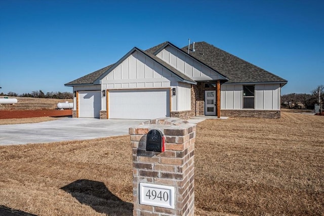 view of front of property with a garage and a front lawn