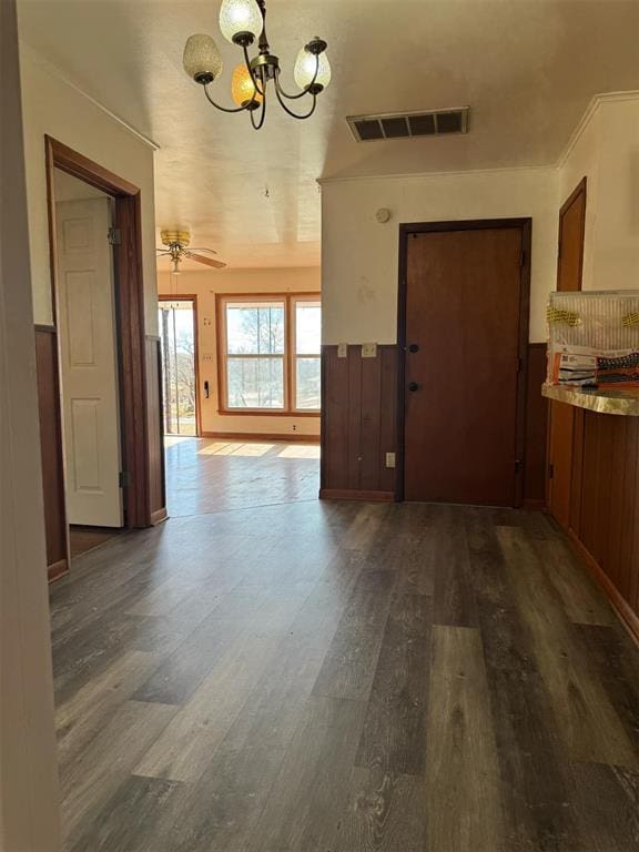 unfurnished dining area with dark hardwood / wood-style floors and a chandelier