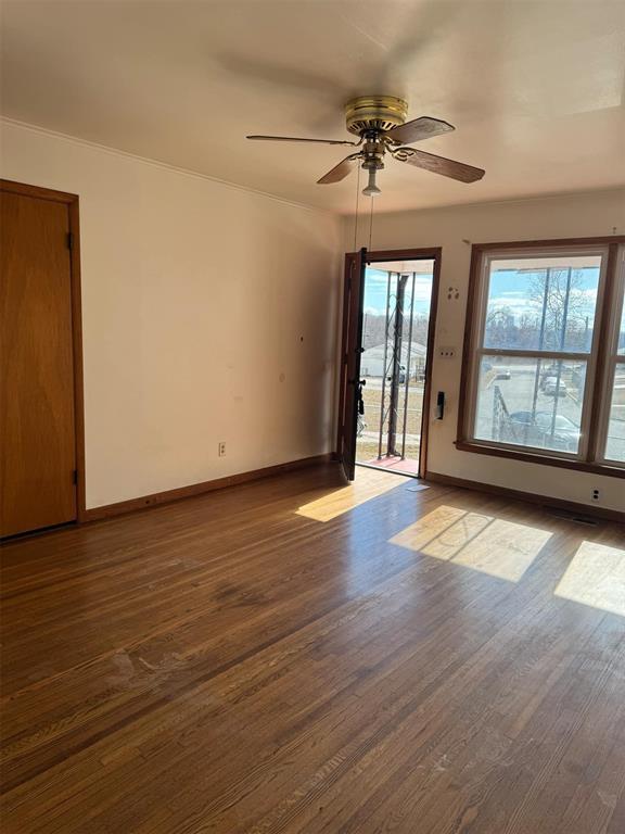 unfurnished room with dark hardwood / wood-style floors and ceiling fan