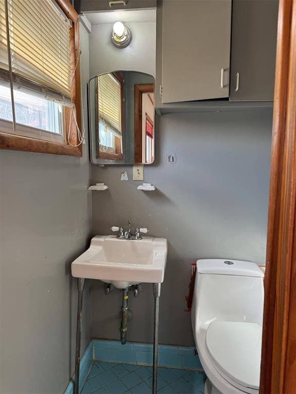 bathroom featuring sink, tile patterned floors, and toilet