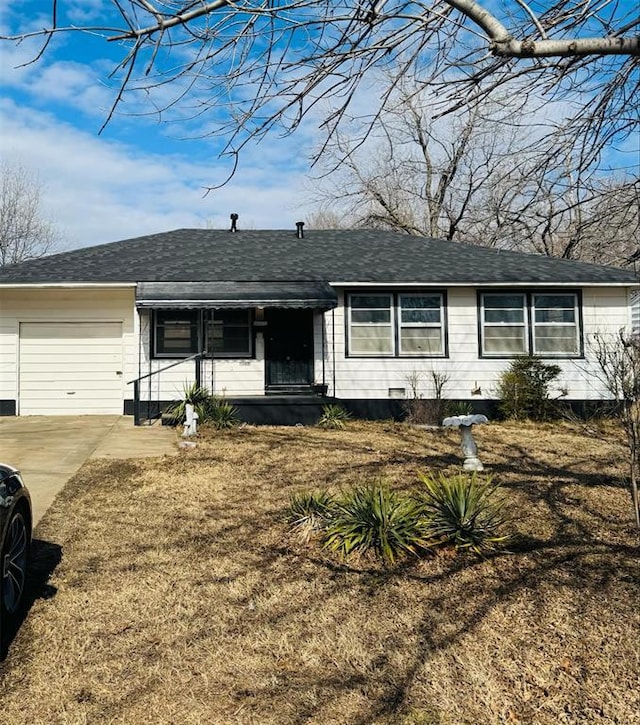 ranch-style house featuring a garage and a front yard