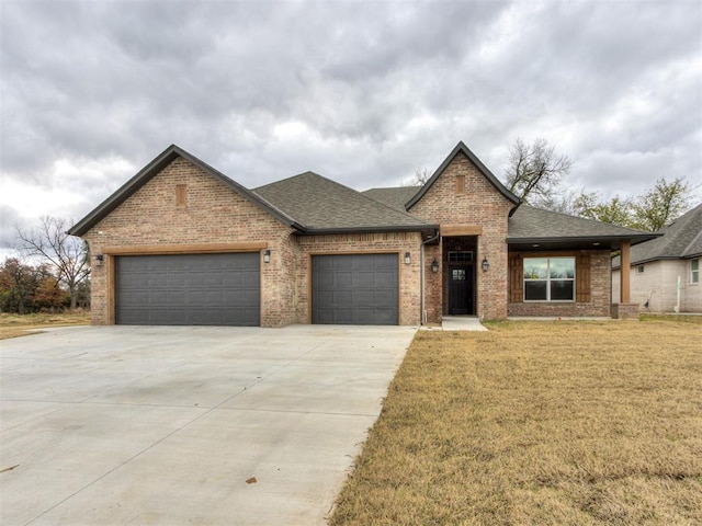 view of front of home with a garage and a front lawn