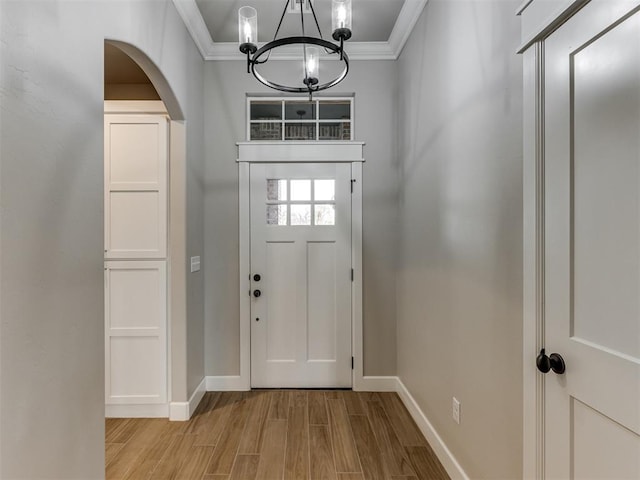 entrance foyer featuring a notable chandelier and ornamental molding