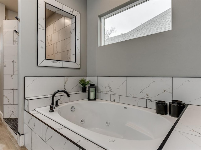 bathroom with tiled tub