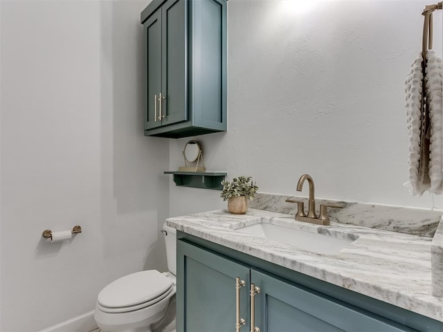 bathroom with toilet and vanity