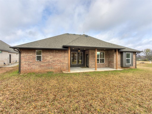 rear view of property with a patio area and a yard