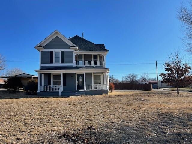 view of front of home with covered porch and a front lawn