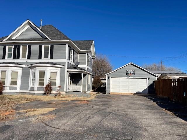 view of side of home with an outdoor structure and a garage