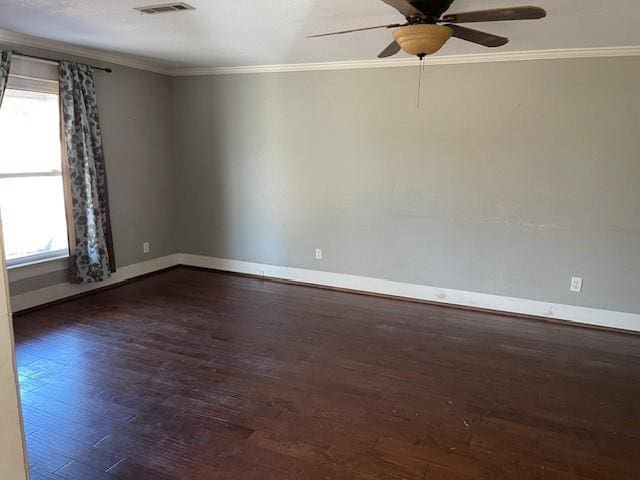 spare room featuring ceiling fan, ornamental molding, and dark wood-type flooring