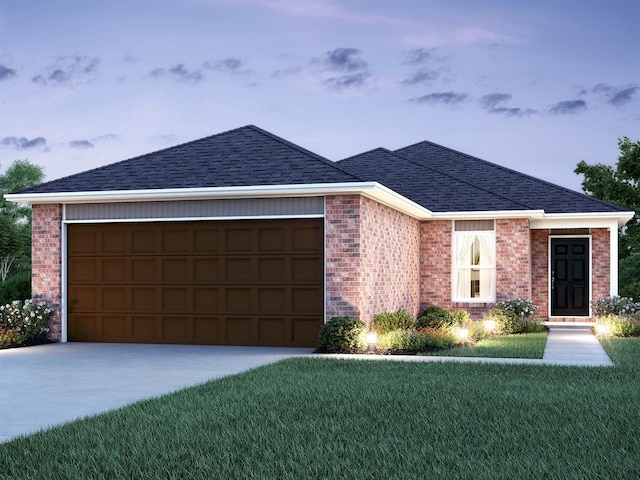 view of front of house featuring a garage and a front lawn