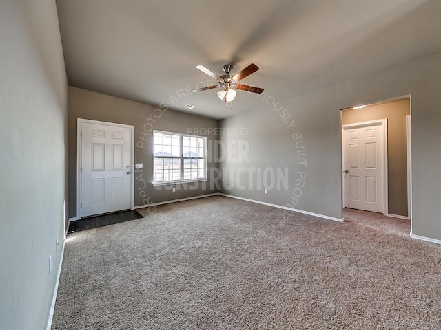 spare room with ceiling fan and carpet