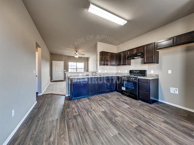 kitchen featuring kitchen peninsula, dark hardwood / wood-style flooring, sink, light stone countertops, and black appliances