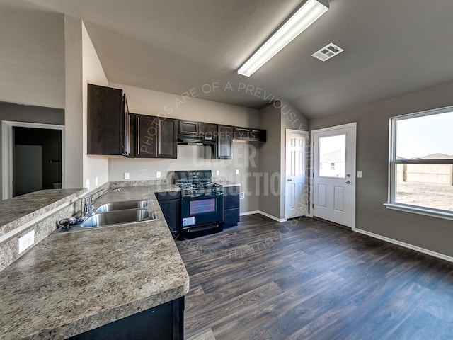 kitchen featuring exhaust hood, dark hardwood / wood-style flooring, sink, black gas stove, and dark brown cabinets